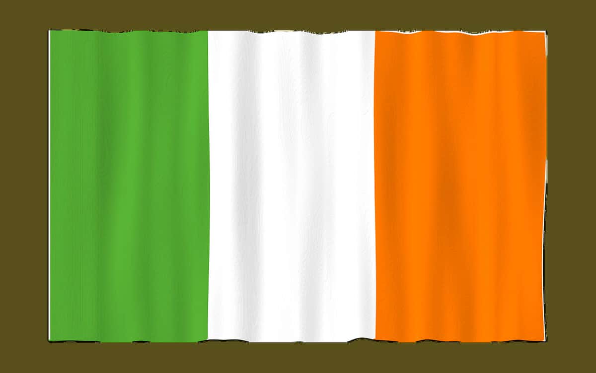 A flag with three vertical stripes: green on the left, white in the centre, and orange on the right, shown with slight fabric ripples.