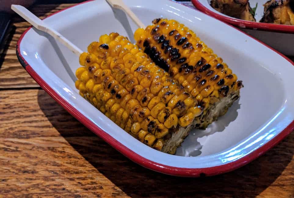 Corn on the cobs in red and white dish