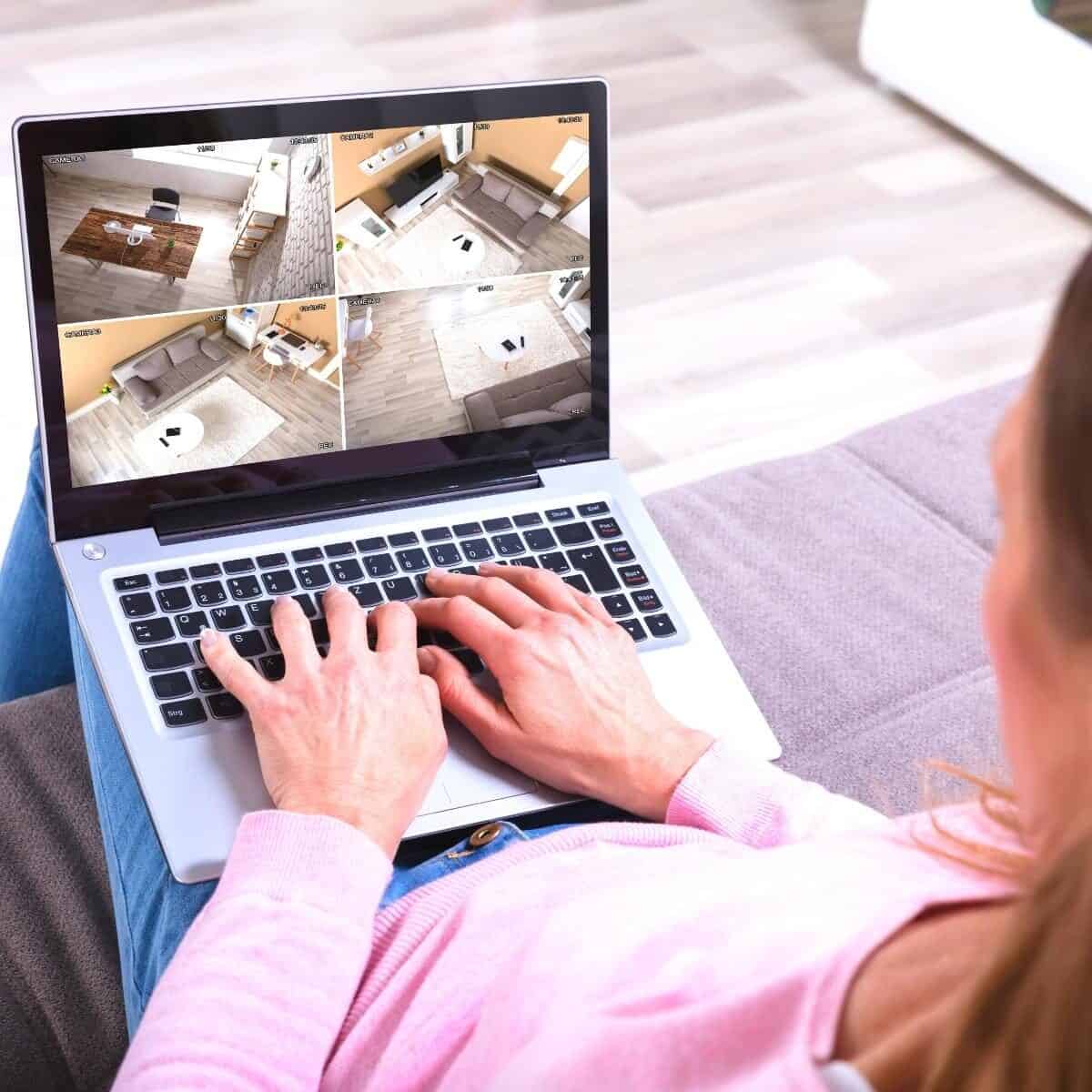 lady looking at security footage on laptop