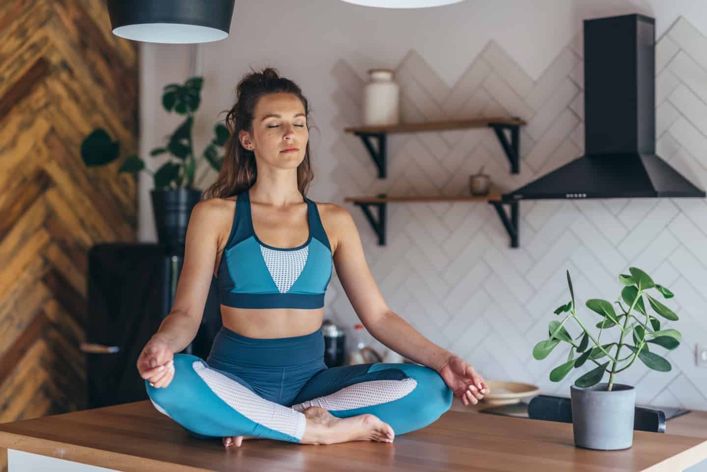 Woman sitting doing yoga as this could change your life this summer