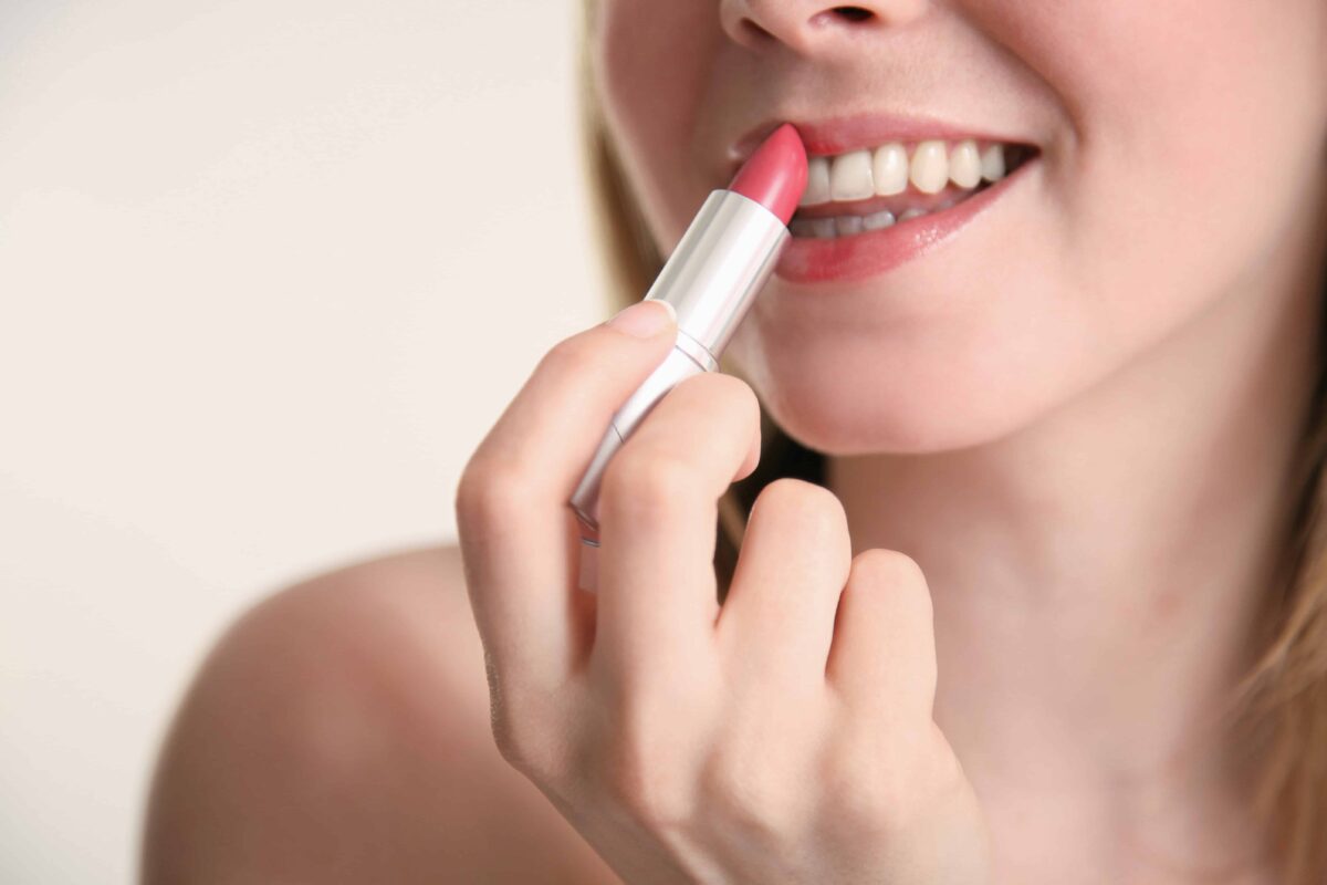 Woman applying lipstick