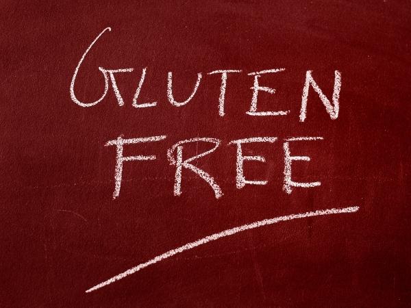 Gluten free written in chalk on a dark red board