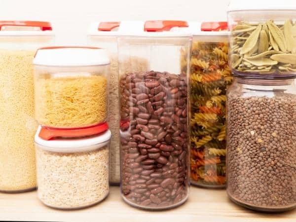 storage jars with rice, pasta, beans and lentils all in different jars