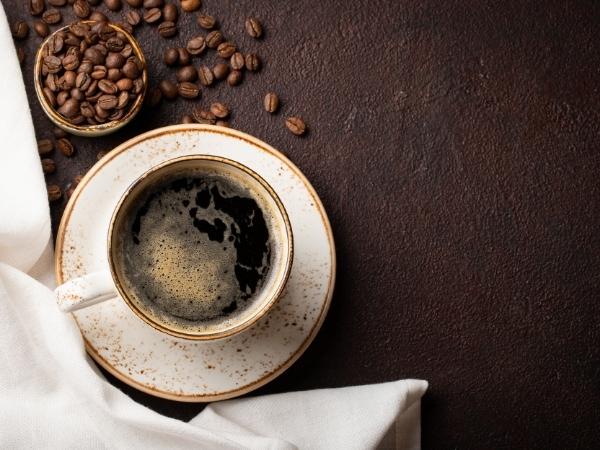 A bowl of food on a plate, with Coffee and Cup