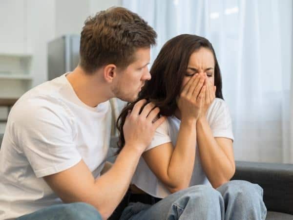 man comforting crying woman