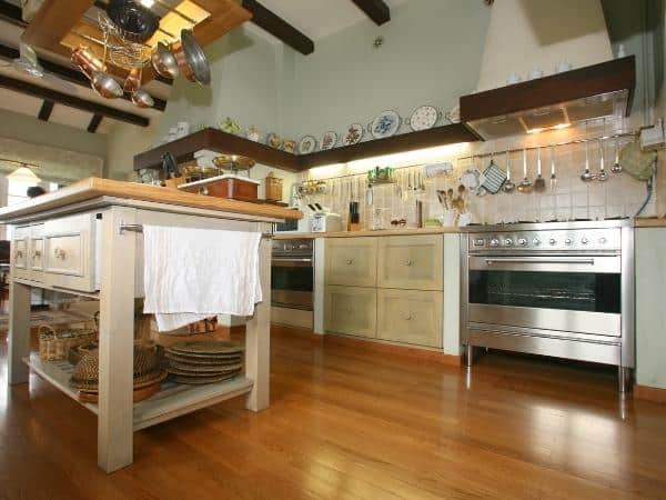 A large kitchen with stainless steel appliances and wooden cabinets