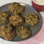 Falafel balls on a grey plate.