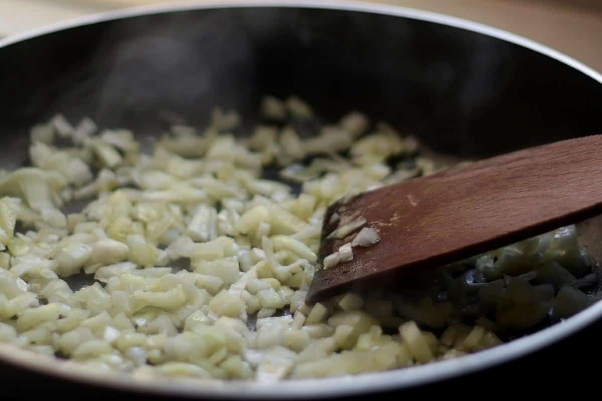 Frying onions in a dark frying pan