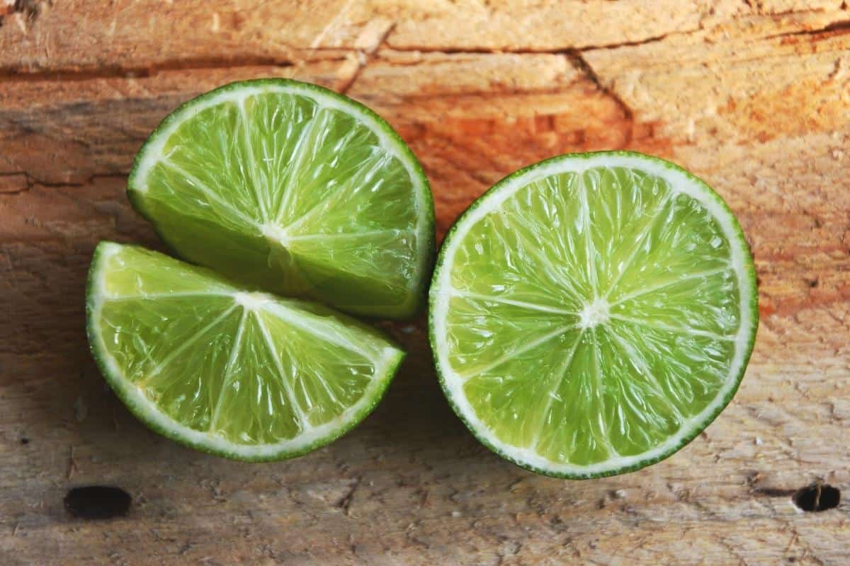 Limes cut open on wooden board