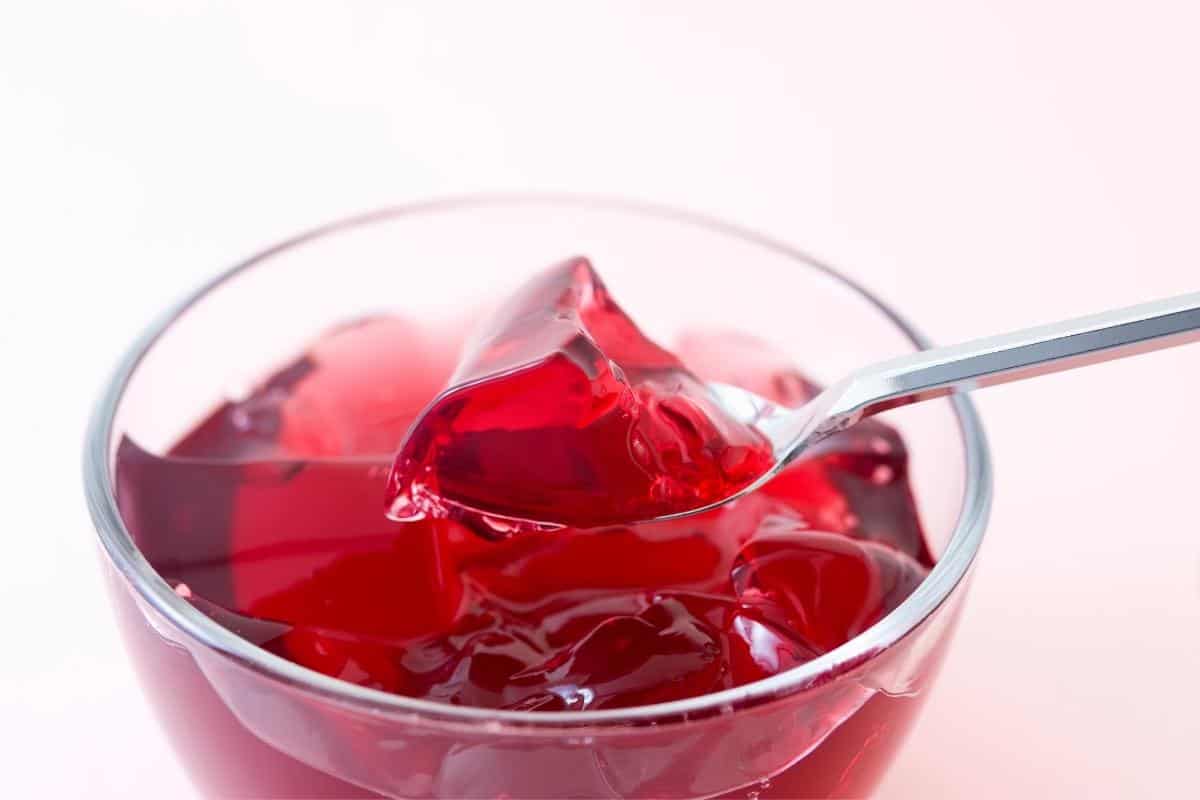 Bowl of red coloured jelly.