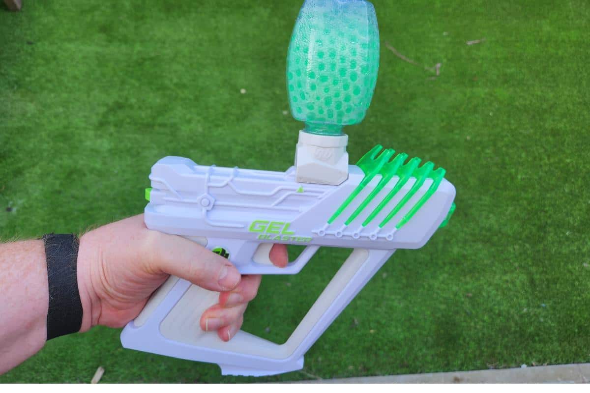 Gel blaster toy being used outside.