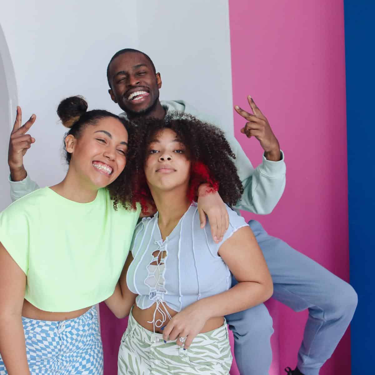 group of teenagers smiling and posing for the camera