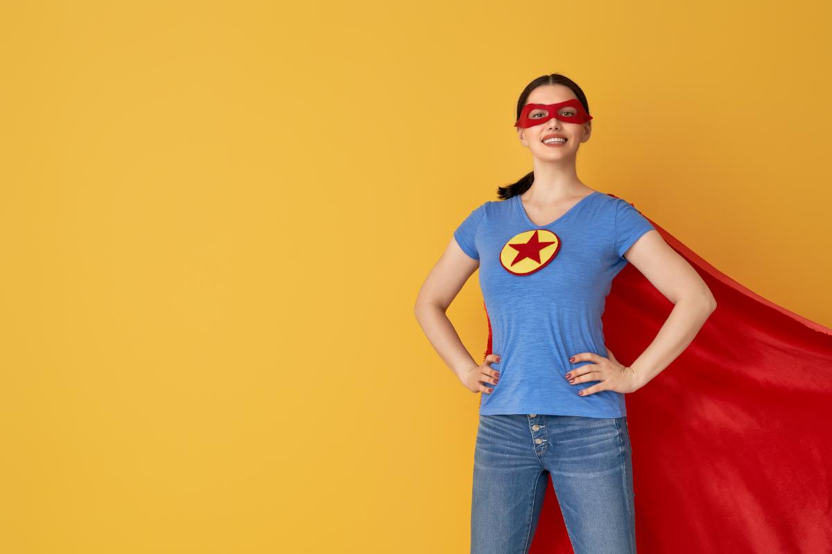 Lady wearing a superhero cape.