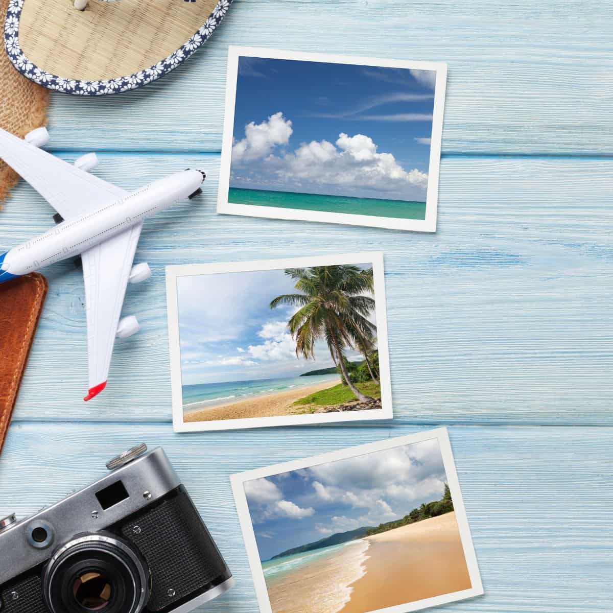 A blue table with holiday photos and a toy plane and camera.