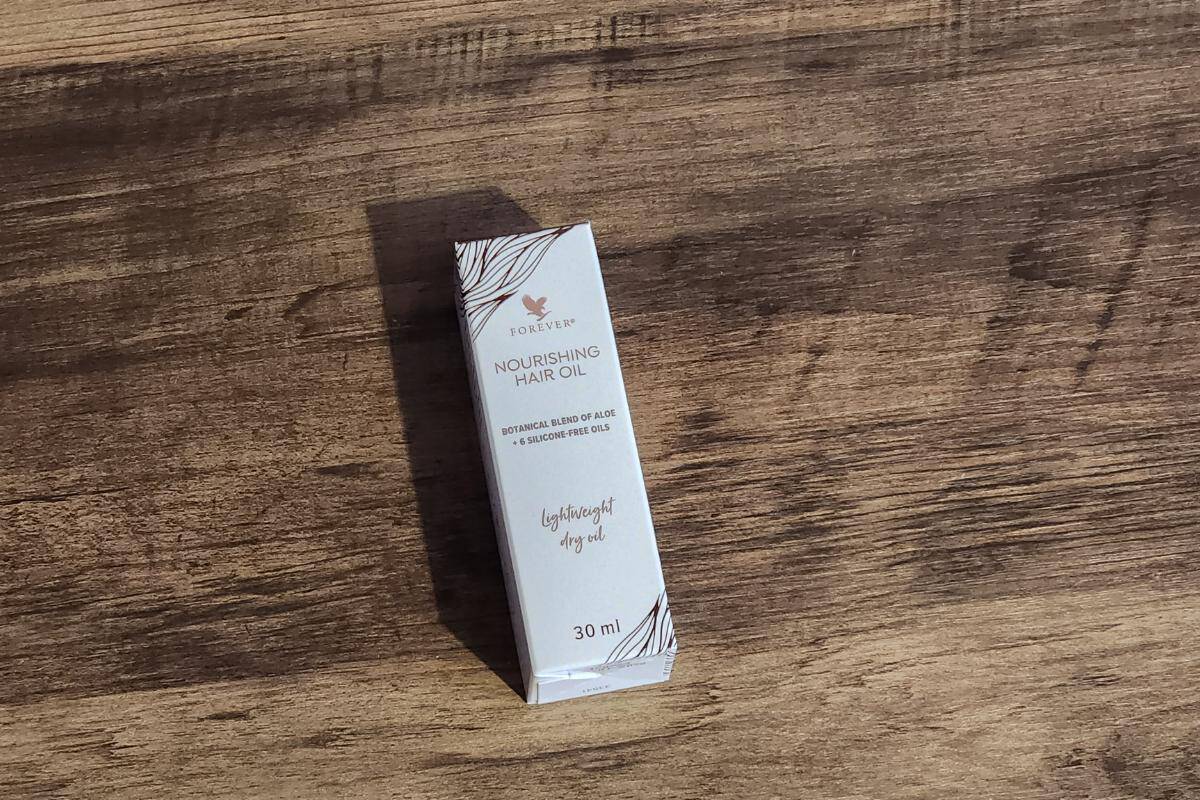 Hair oil bottle in small box.