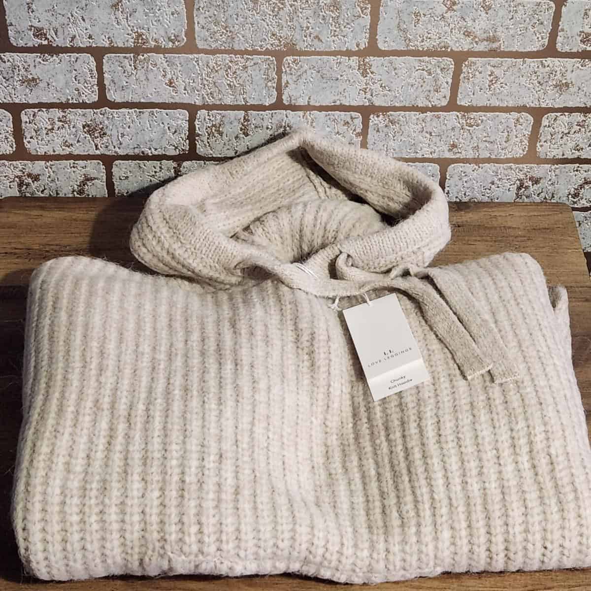 A knitted cream hoodie.