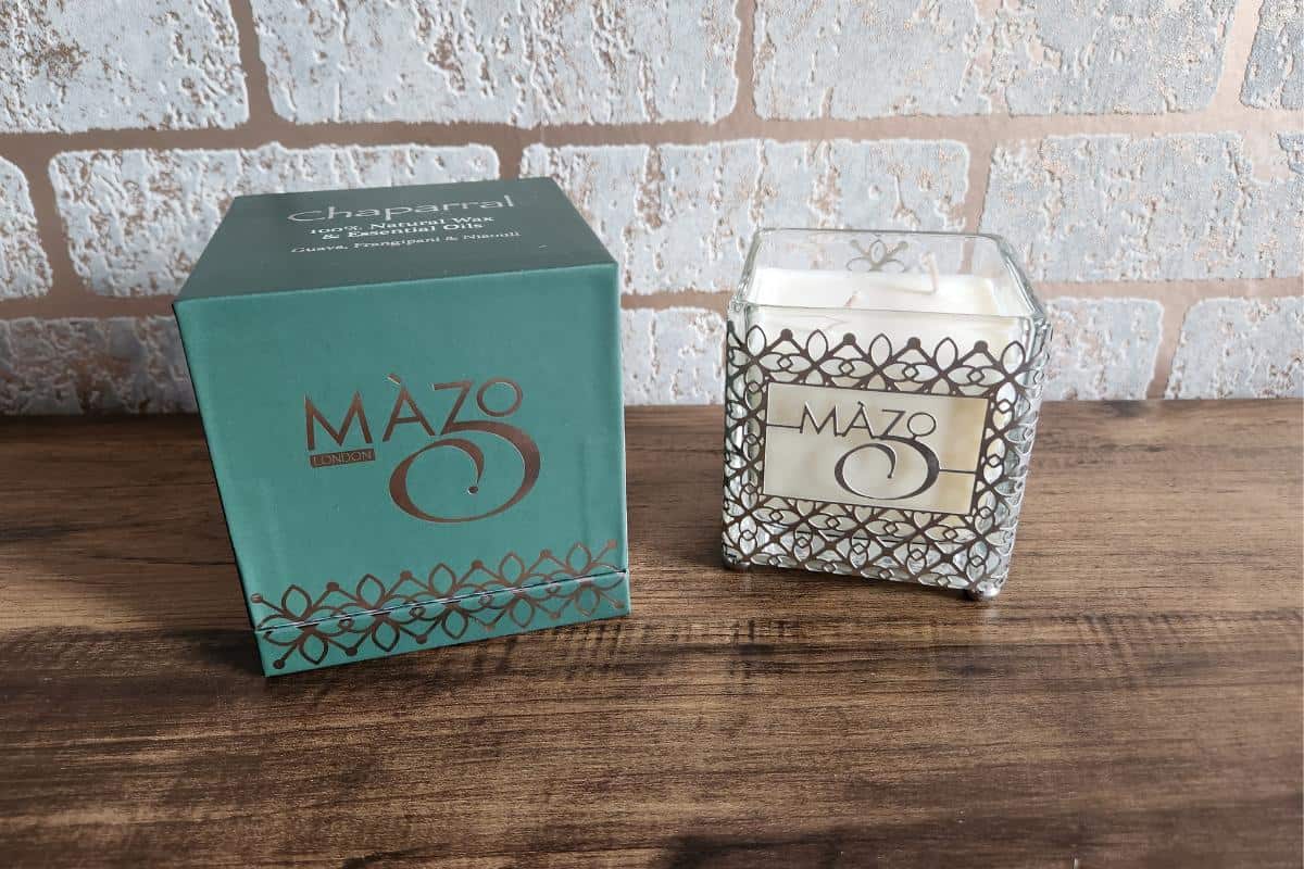 Square stylish candle with Maxo written on the front.