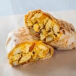 Mexican burritos with chicken and rice showing inside the wrap.