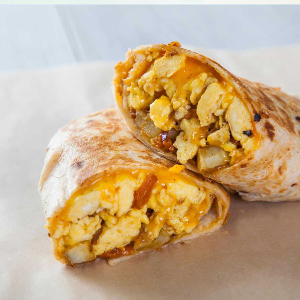 Mexican burritos with chicken and rice showing inside the wrap.