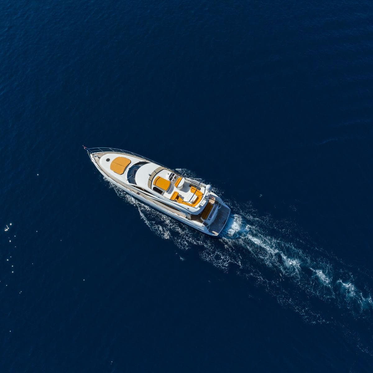 Aerial view of a yacht on a blue sea.