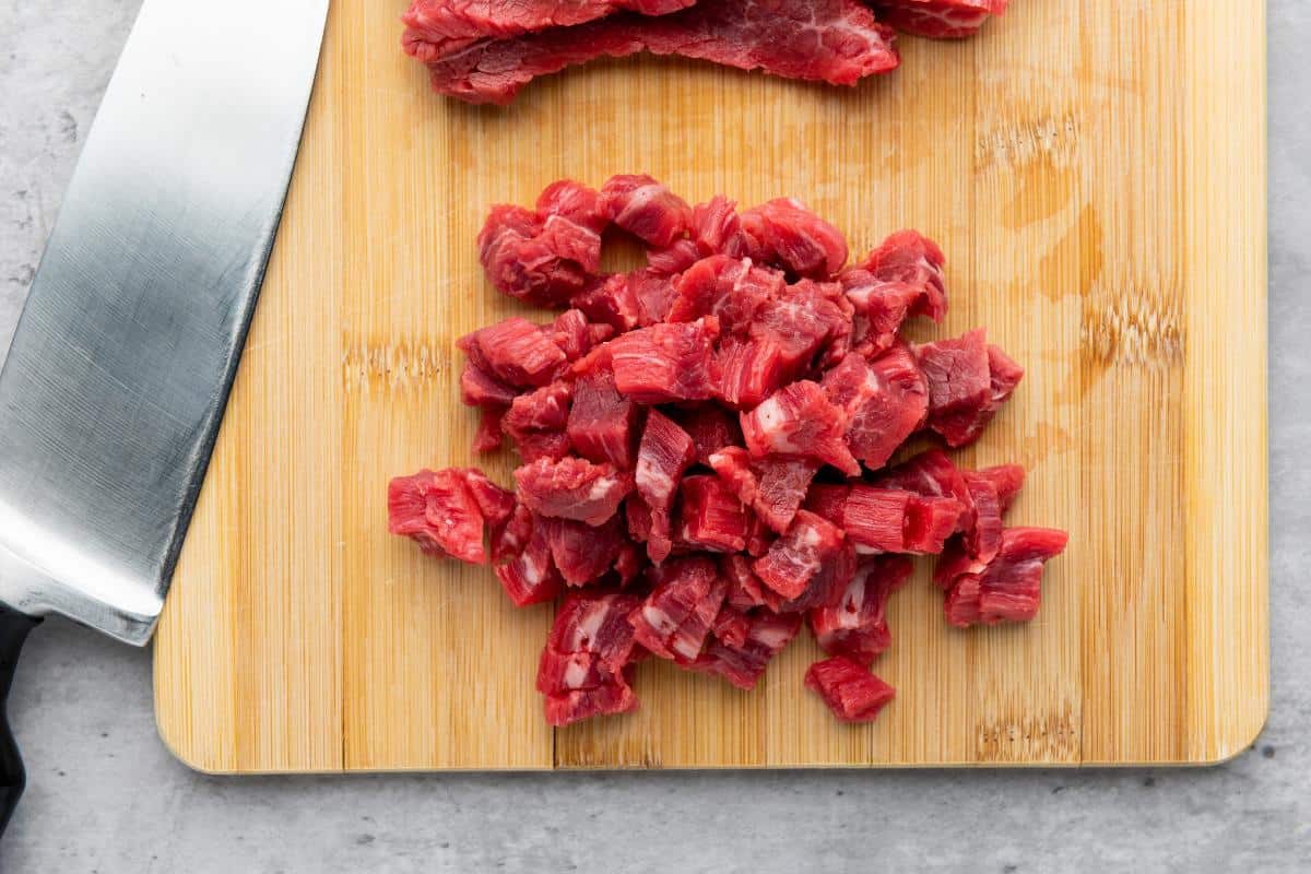 chopped flank beef on a chopping board.