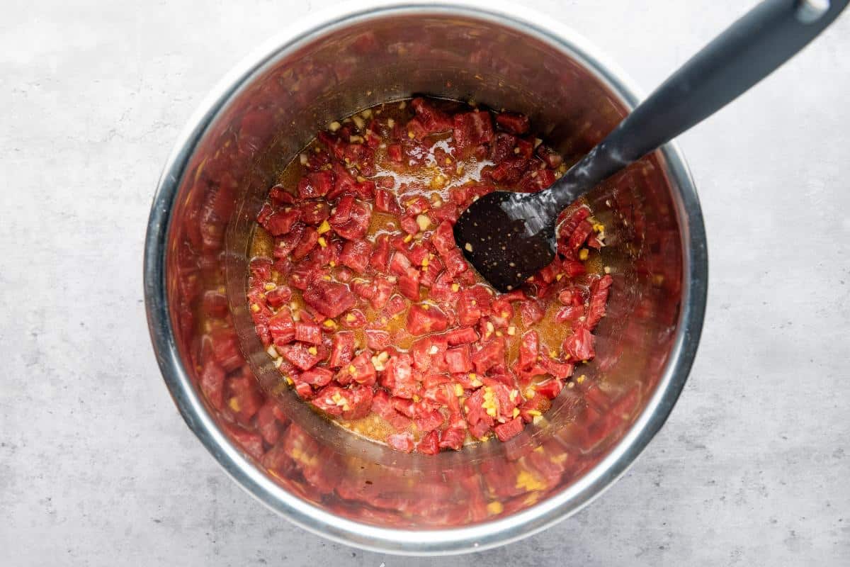 mixture in slow cooker for Mongolian beef before it is cooked.