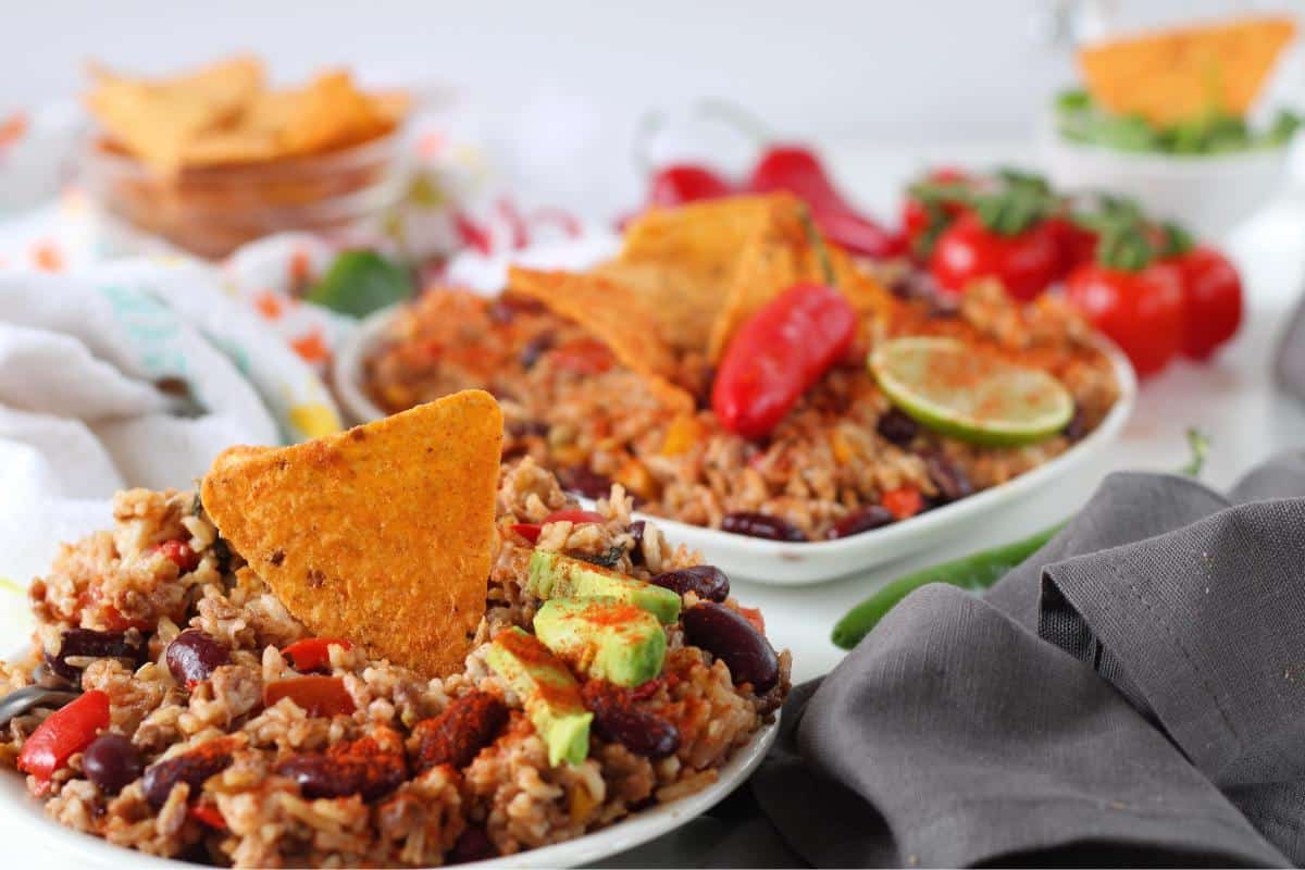 vegan chilli con carne with a a tortilla chip in the top.
