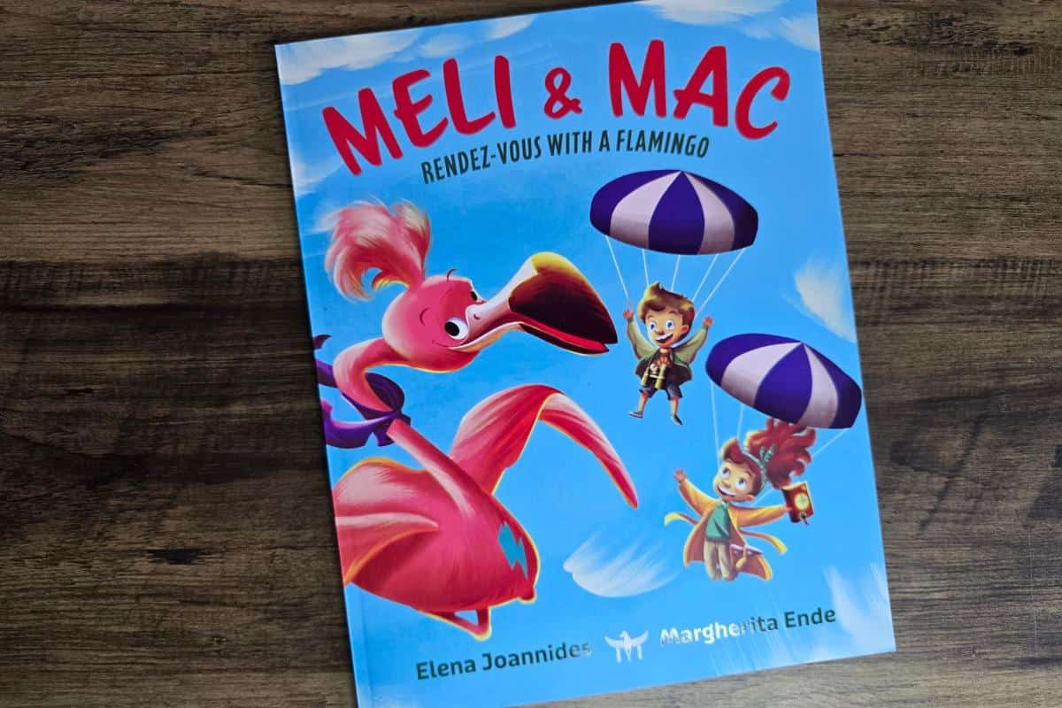 Cover of "Meli & Mac: Rendez-vous with a Flamingo" invites young readers into an adventure, featuring characters flying alongside a flamingo using parachutes against a vibrant blue sky. This engaging scene captures the essence of enchanting books for children.