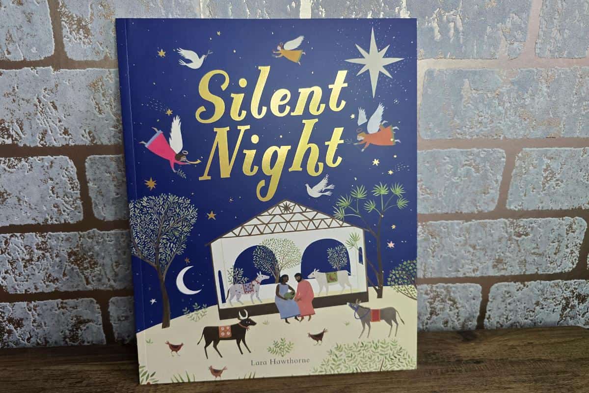 Silent Night" is a charming book for children, featuring a beautifully decorated cover with a nativity scene, twinkling stars, graceful angels, and gentle animals.