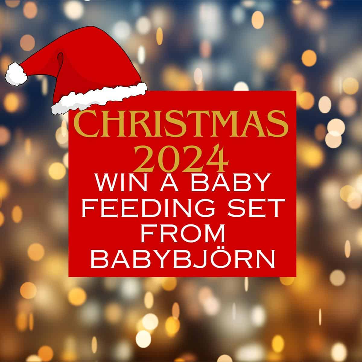 Festive background with blurred lights; text reads: "Christmas 2024: Win a Baby Feeding Set from BabyBjörn" adorned with a Santa hat.