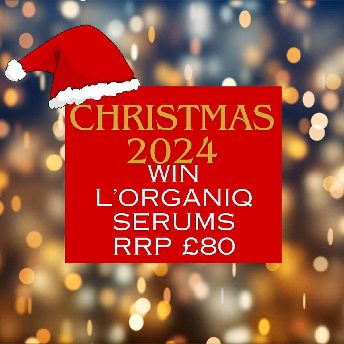Festive background with text: "Christmas 2024. Win the L'ORGANIQ Serum Trio worth £80" inside a red box with a Santa hat.