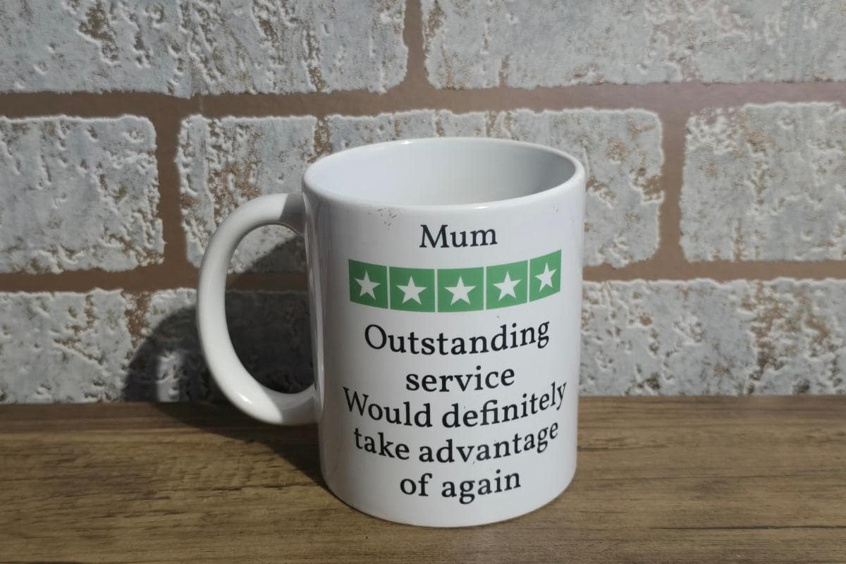 A white mug featuring a green star rating design and the text: "Mum, Outstanding service. Would definitely take advantage of again." A quirky touch from the Mr. Inappropriate Review collection that'll make her laugh and blush.