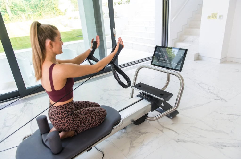 a woman on a reformer pilates machine