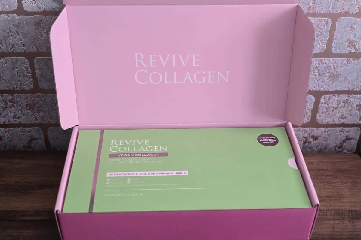 A pink box with “Revive Collagen” inside the lid holds a green package labeled “Revive Collagen Vegan.” This plant-based beauty product displays key vitamins and ingredients on the front for an easy collagen review.