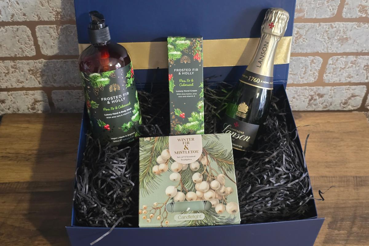 A luxurious Christmas Gift box featuring Lanson champagne, Frosted Fir & Holly hand wash and cream, plus a Winter & Mistletoe Candlelight candle—perfect for any Christmas Gifts list or as inspiration in your Gift Guide for Her.