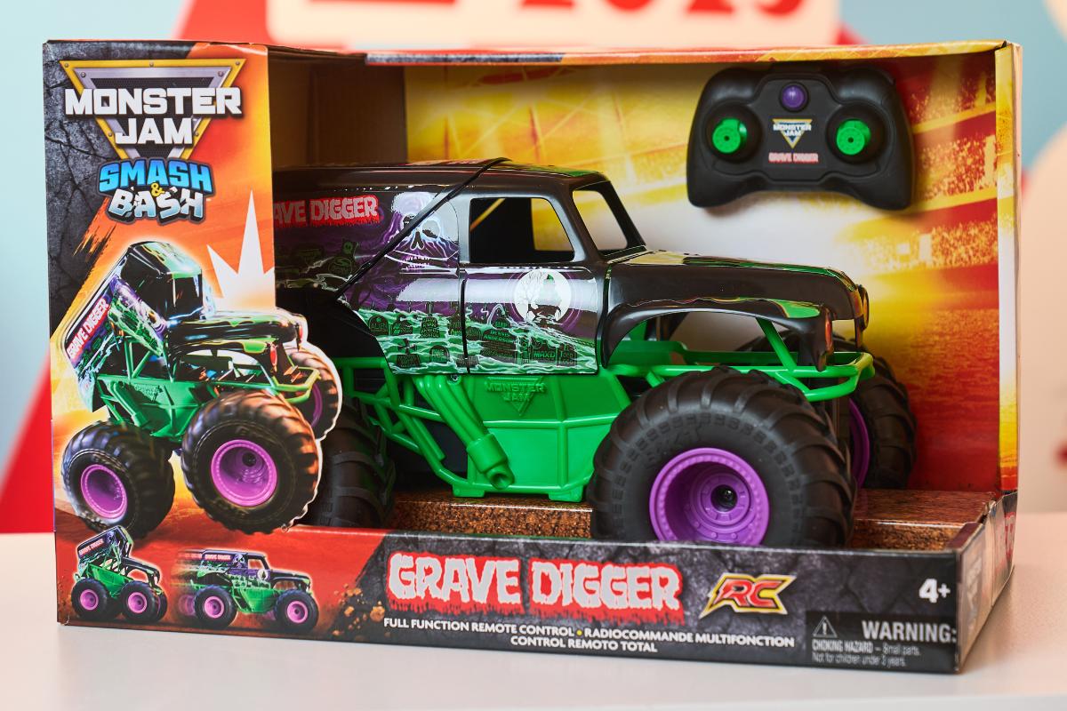 A Monster Jam Grave Digger remote control toy truck in a display box with bold graphics and green and purple colors. Perfect for Kids, this Top Toys 2025 favorite comes with a black remote control. Ideal for Christmas List, suitable for ages 4 and up.