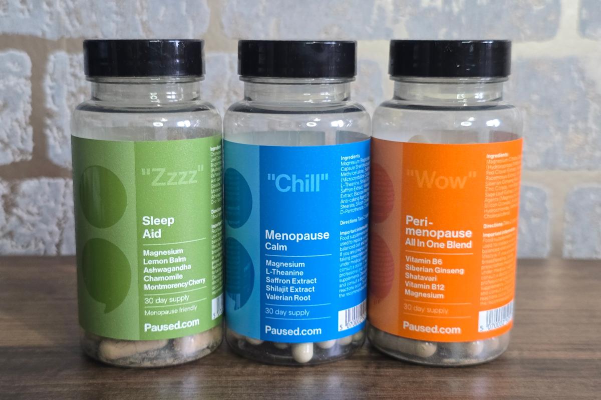 Three supplement bottles labeled "Zzzz" Sleep Aid, "Chill" Menopause Calm, and "Wow" Perimenopause with ingredient lists are displayed against a light brick background—perfect picks for any Christmas Gift Guide.