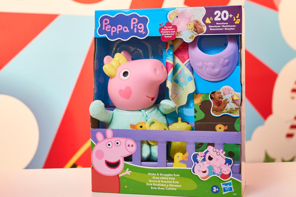 A boxed Peppa Pig toy set includes a plush Peppa Pig doll in pajamas, a baby bottle, blanket, and accessories. Colorful packaging with Peppa Pig branding makes it an Ultimate Toy for the Christmas List for Kids ages 3 and up.