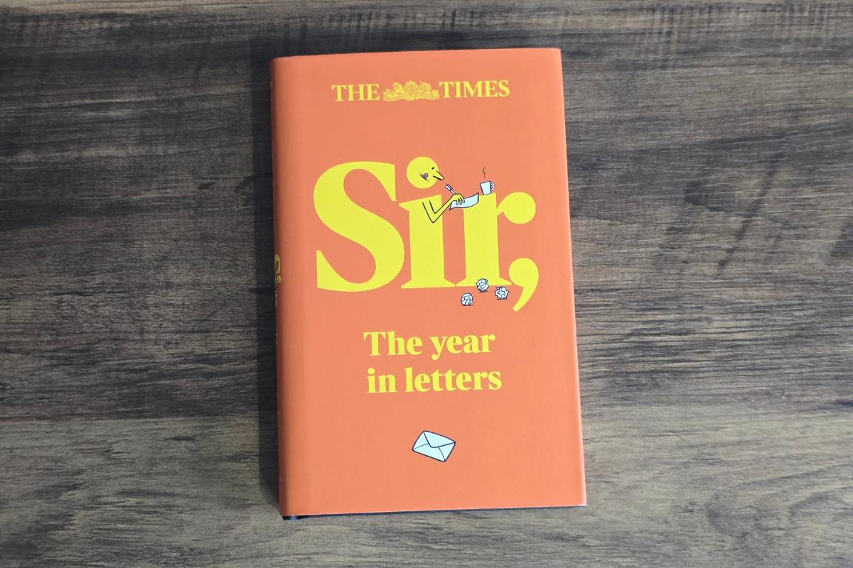 A hardcover book titled "Sir, The year in letters" by The Times rests on a wooden surface. This vibrant orange cover makes a thoughtful addition to any Christmas Gift Guide, especially as one of the best gifts for him.