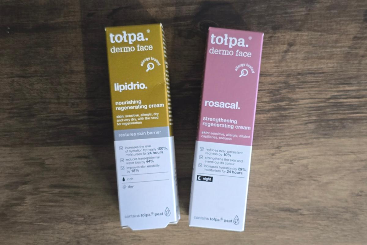 Two rectangular boxes of Tołpa dermo face creams, ideal as Christmas Gifts or part of a Christmas Gift Guide, sit on a wooden surface—one yellow labeled "lipidrio," the other pink labeled "rosacal"—both listing product benefits and usage details.