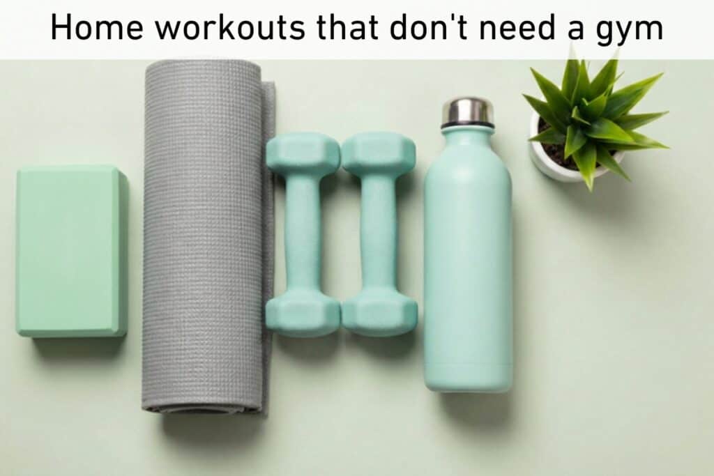A yoga mat, two dumbbells, a water bottle, a yoga block, and a small plant on a flat surface with the text "home workouts that don't need a gym" at the top—everything you need for your next exercise session right at home.